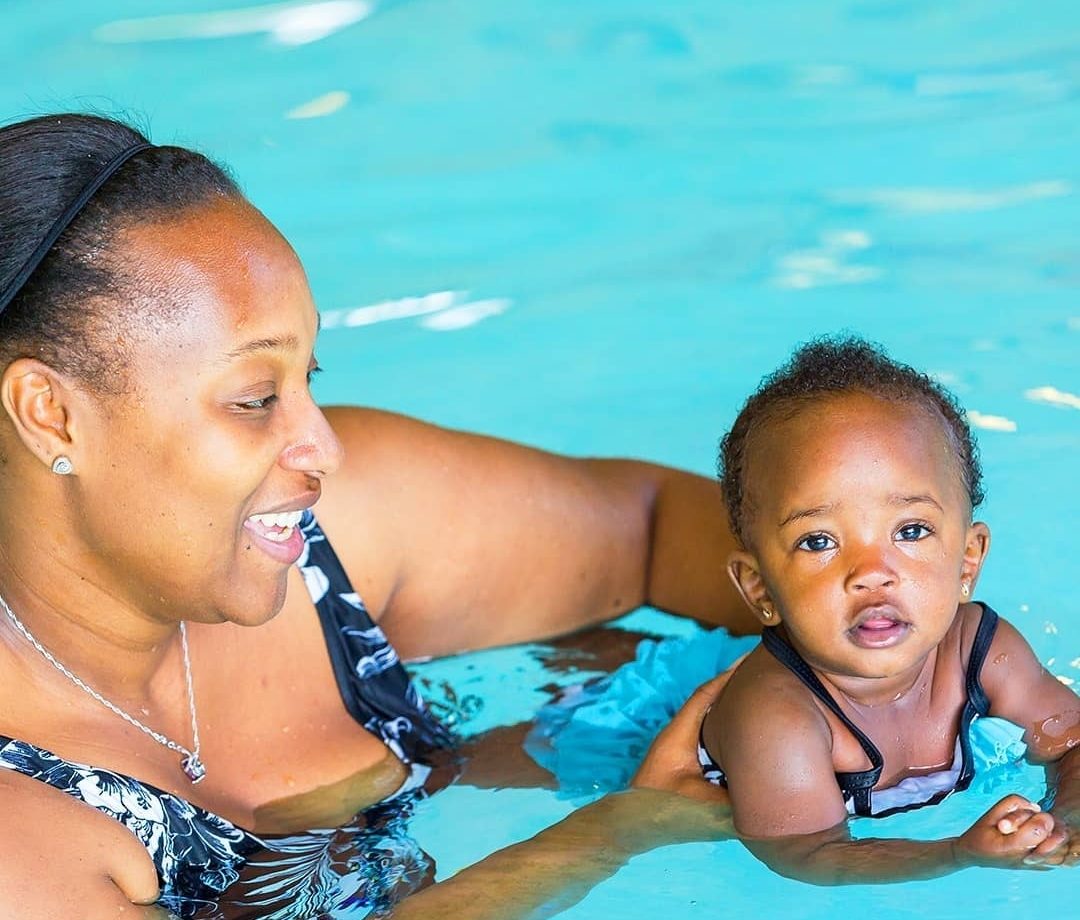 Photo d'une mère qui aide son enfant à nager